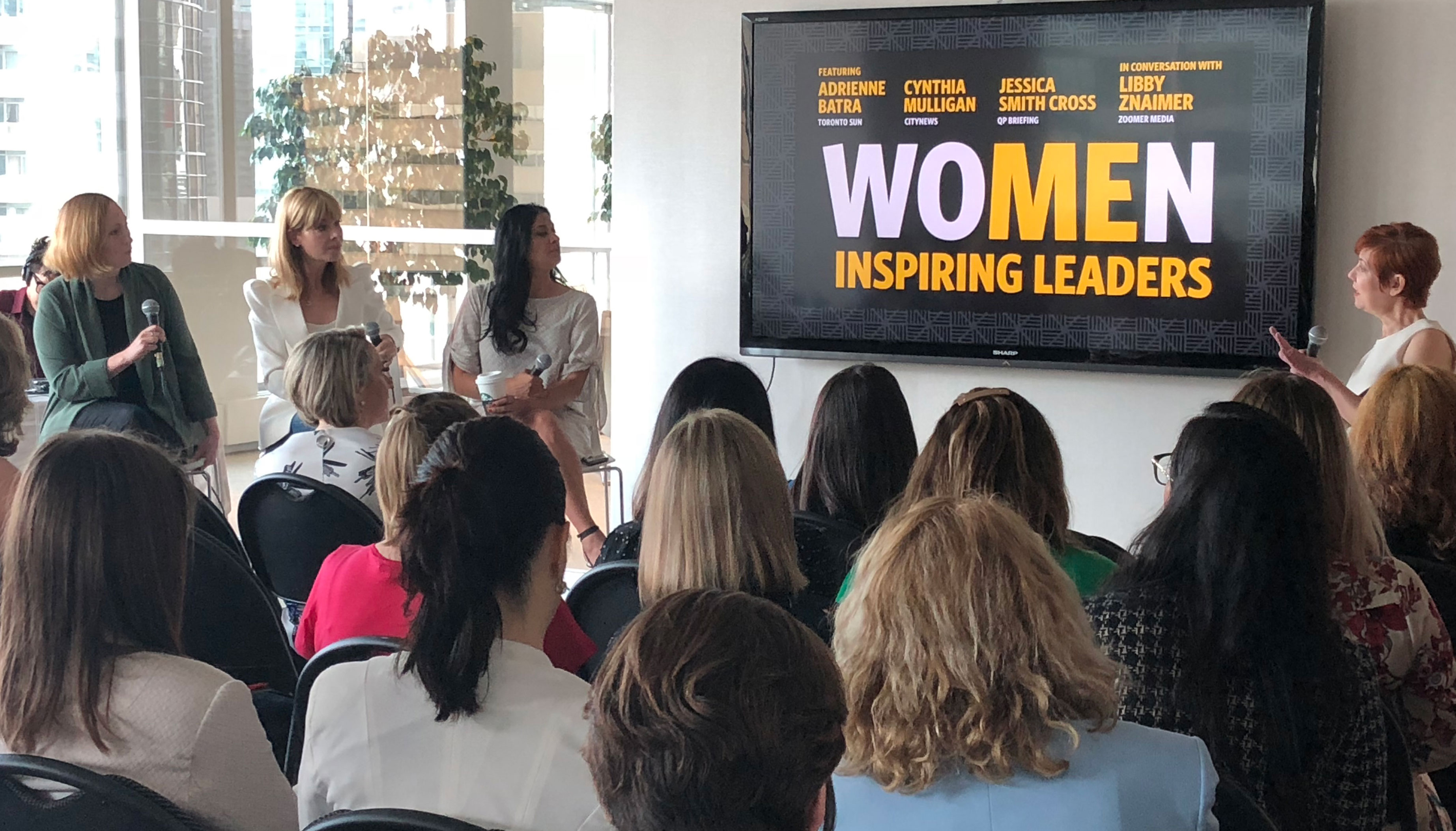 Women looking at the Women Inspiring presentation